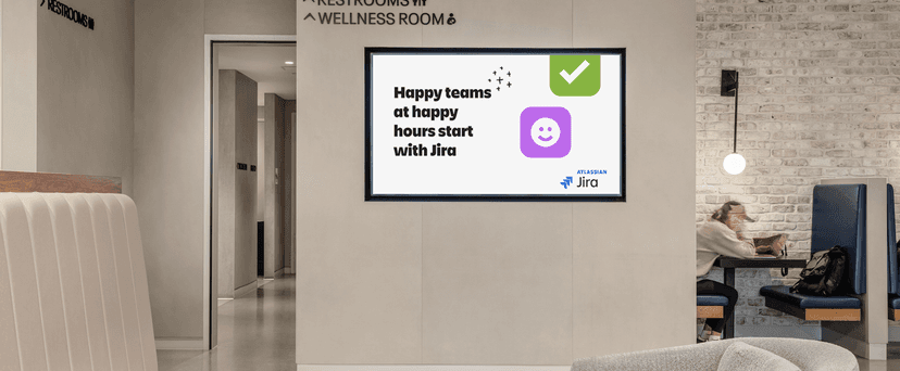 office setting with Jira sign stating, "Happy teams at happy hours start with Jira"
