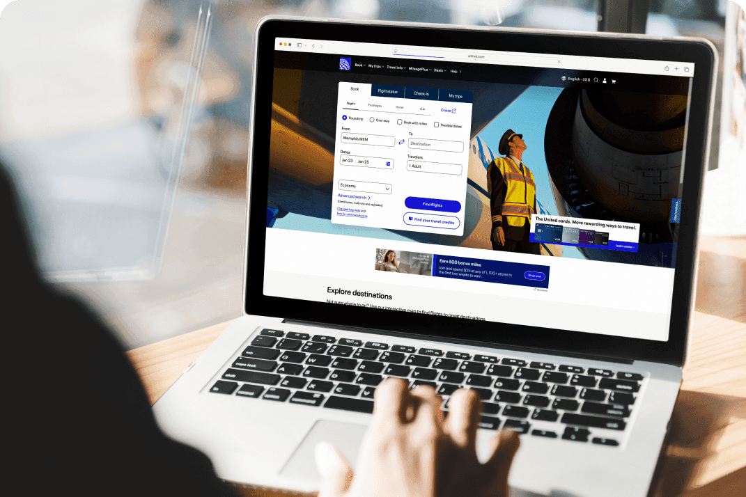 A person at a table typing on their tablet.